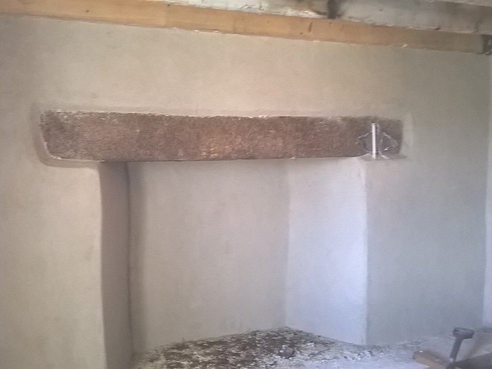 Lime plaster insulation applied to fireplace surround